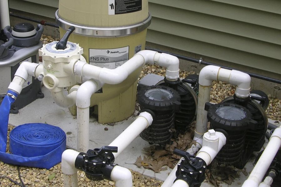 Pool equipment pad with filter, pumps, and valves